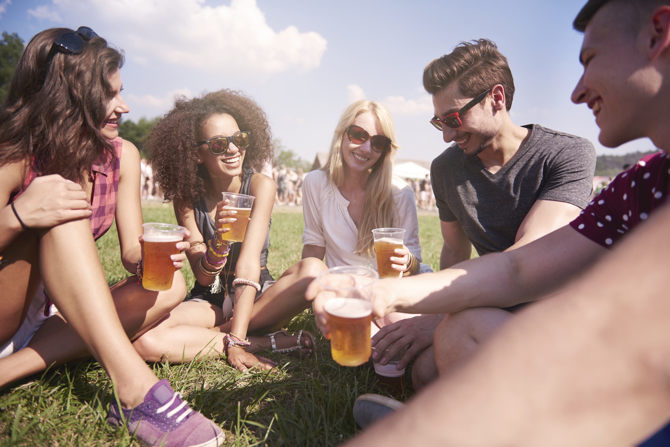 A group of friends having a beer at the park in Germany